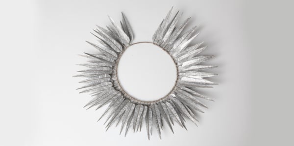 Photo of necklace made up of silver leaves around edge