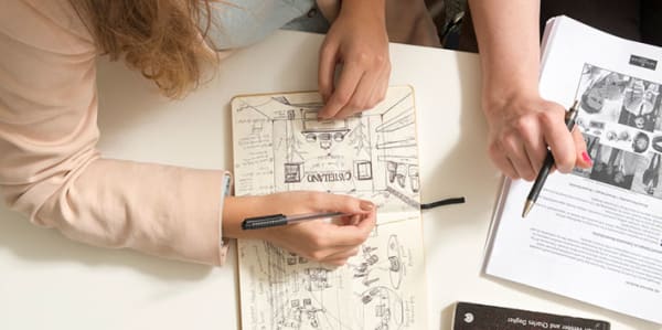 Researchers making notes at a desk