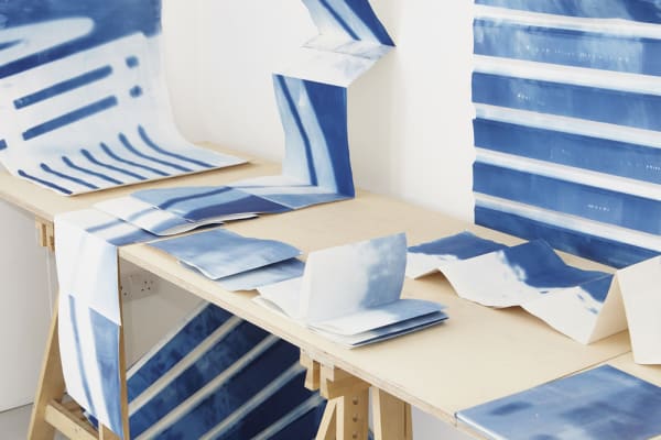 Artwork with blue stripes. Prints installation by Ziyan Lu