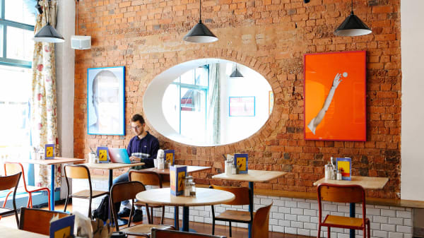 Student working on a laptop in a coffee shop