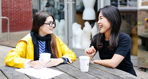 Students talking while sat at table