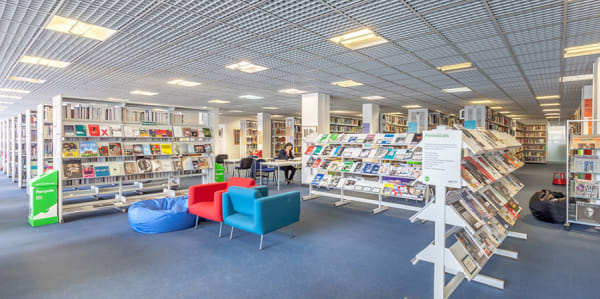 Rows of books and seated area at LCC Library
