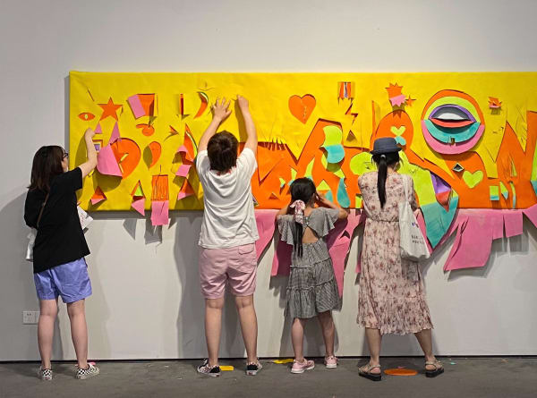People creating art on wall