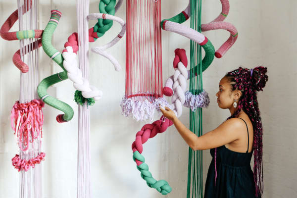 student admiring textile work