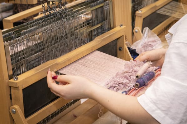 A student using a loom 