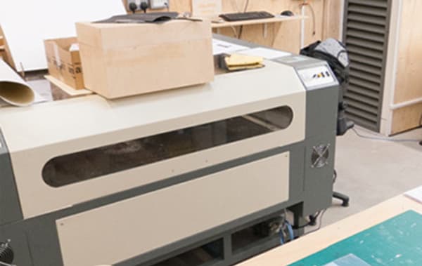 A large machine which has a wooden box on top of it