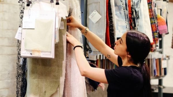 A woman looking at materials hung on a wall