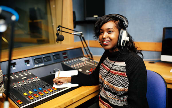 A journalism student working in one of the audio studios.