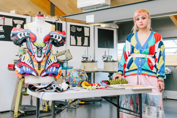 CSM graduate Paolina Russo pictured in a studio with her multicoloured design pieces