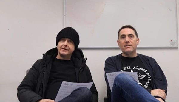 two men talking into the camera