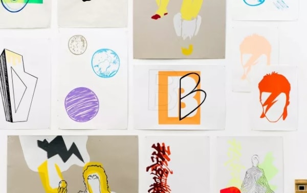 Photo of colourful pieces of art hanging on a white background