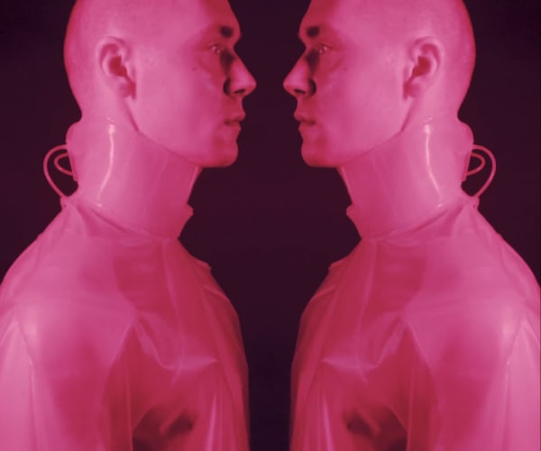Two male models in pink atmospheric light.