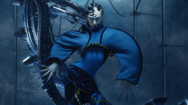 Figure wearing blue garment in robotic lanscape