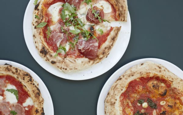 Three pizzas on a table