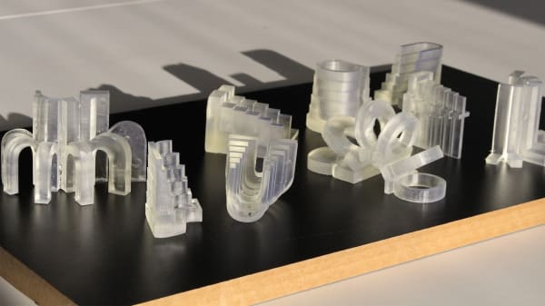 frosted clear translucent sculptures on a black table