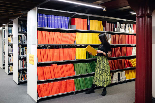 A student reading a book in the library 
