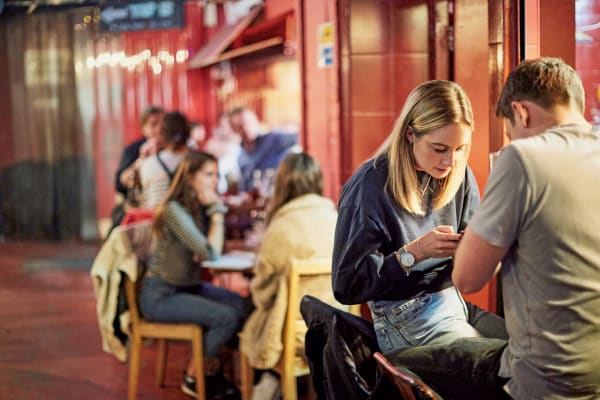 Tooting nightlife with people at a bar.