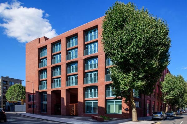 Exterior of Wick Park, showing 6 story red brick building with modern tall windows