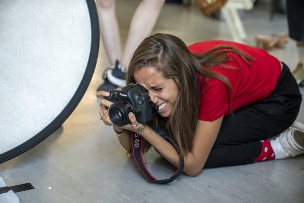 Student taking photographs during shoot