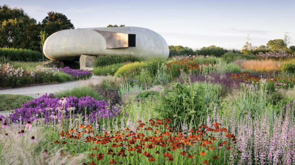 Photo of the Radić Pavilion at Hauser & Wirth in a field of purple flowers and grass