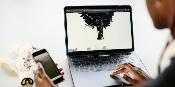 Student working on her laptop and phone