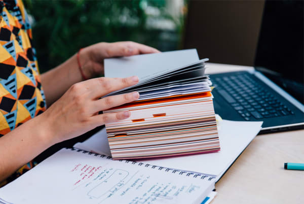 Side view of a woman's hands holding a book
