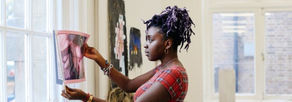 Student holding up artwork