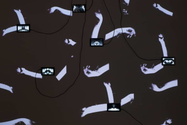 Lot of hands projected onto a wall