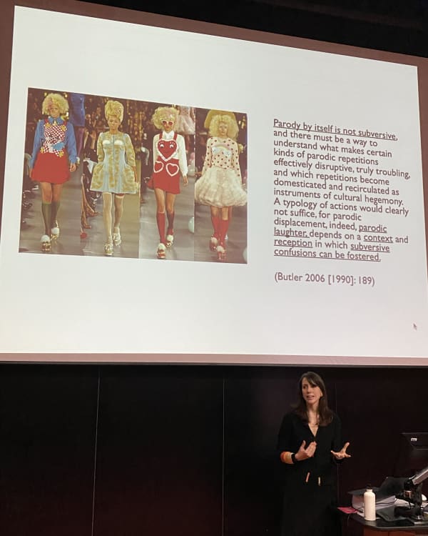 Person giving presentation with models on screen