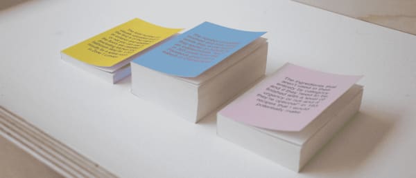 Three books of different sizes sitting on a table