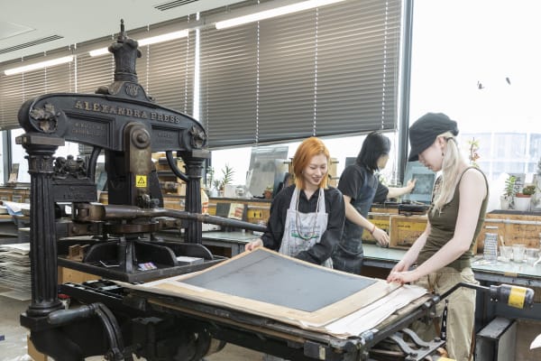 Students working at a printing press