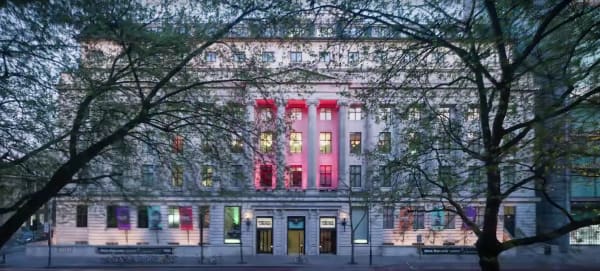 The exterior of the Wellcome Collection seen through trees
