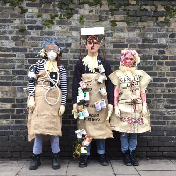 3 students wearing costumes.