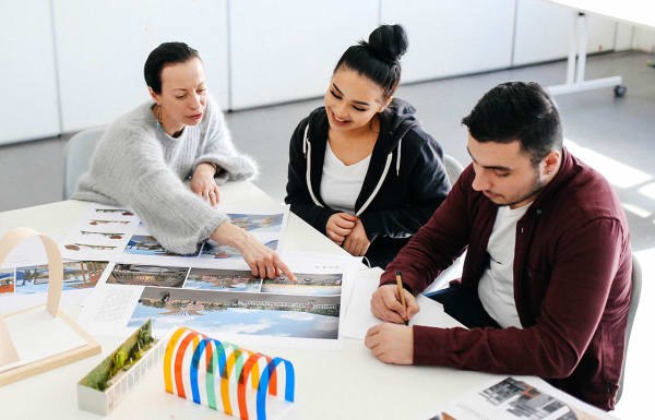 Students with tutor pointing at spatial designs