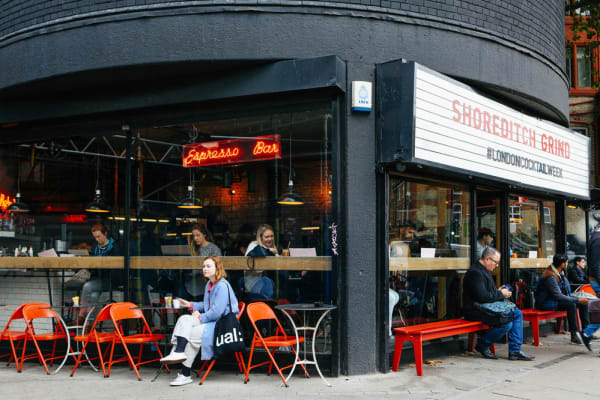 girl sat outside a cafe