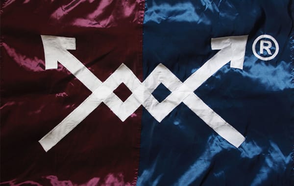A navy and purple silk flag which has two arrows embroidered onto the middle 