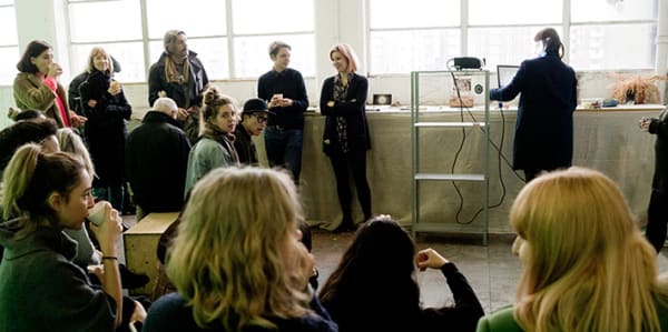 Photo of a group of students facing a large window