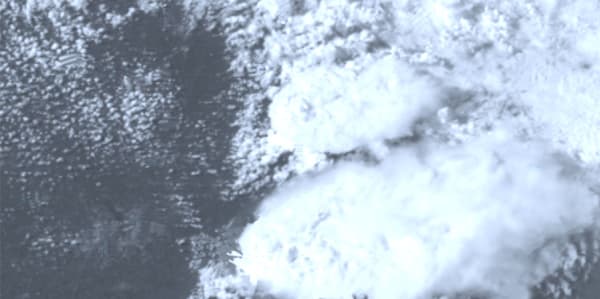 Abstract digital image, resembles grey clouds or smoke over a dark background