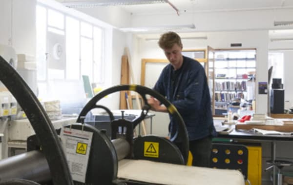 A person using a printing press