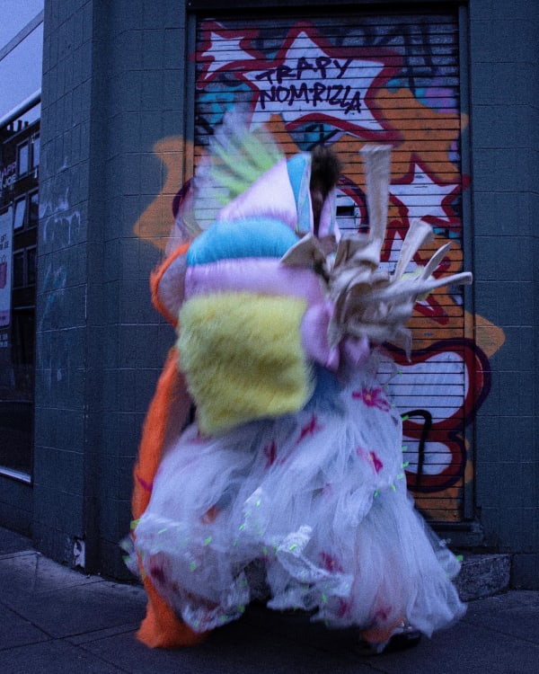 Figure wearing colourful padded garments
