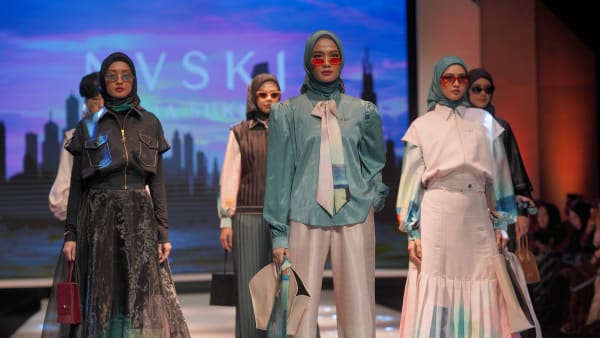 Two rows of three women standing on a fashion ramp
