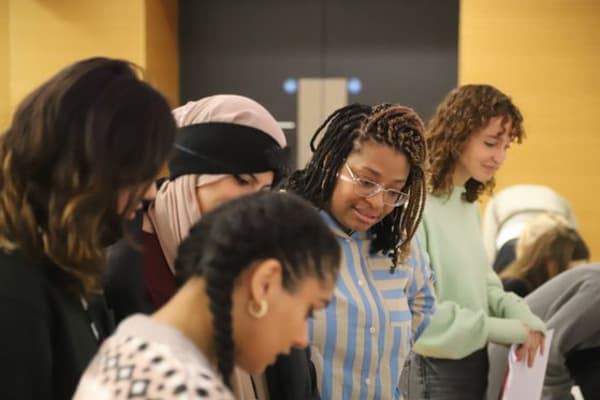 A group of people looking at something 