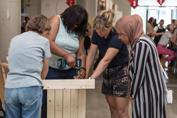 A group of women working with a drill