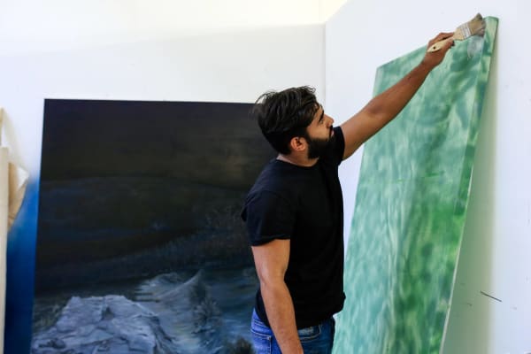 Student paint on a large canvas.