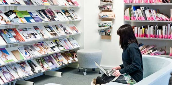 Student in the LCF Library using their laptop