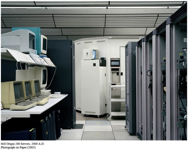 Photograph of a room of computer servers and wires 
