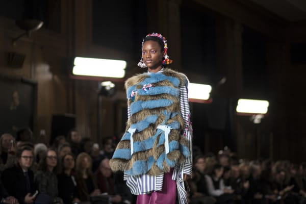 A female model wearing fur and stripes