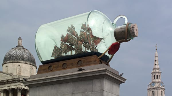 A statue of a chip inside a glass bottle