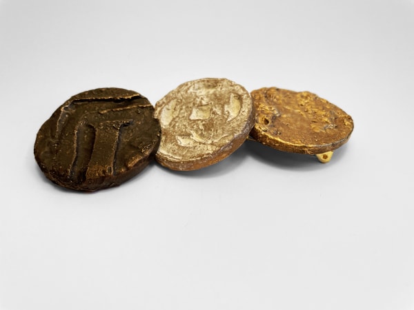 3 coin-like objects placed in a row