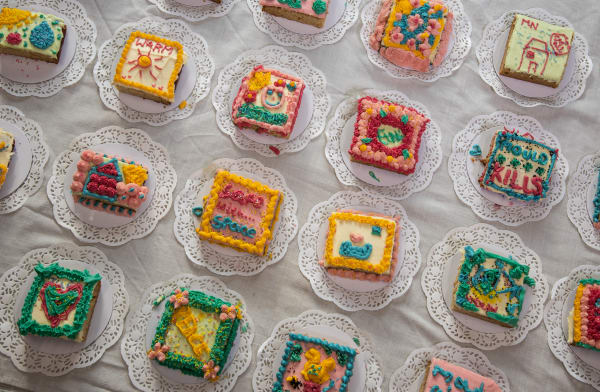 A birds-eye shot of colourful cakes placed on doilies